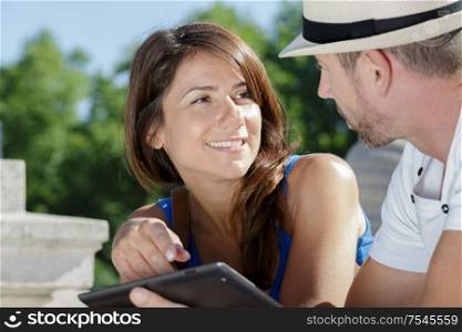 couple using a tablet out in the city