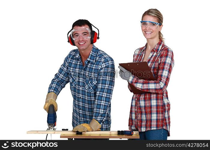 Couple using an electric jigsaw