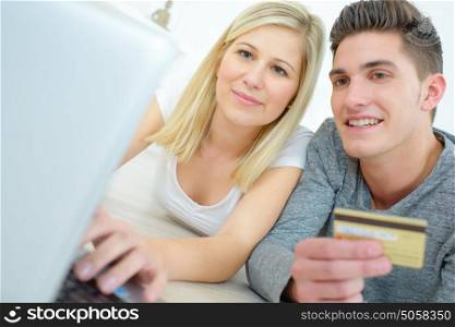 couple using credit card to make online purchases