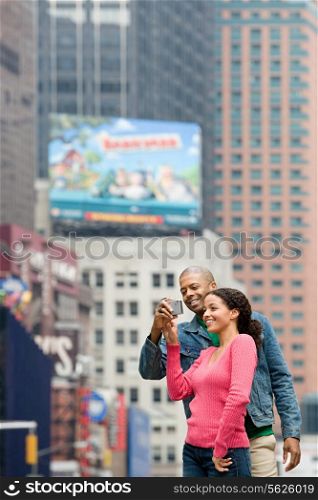 Couple using digital camera