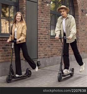 couple using electric scooters outdoors