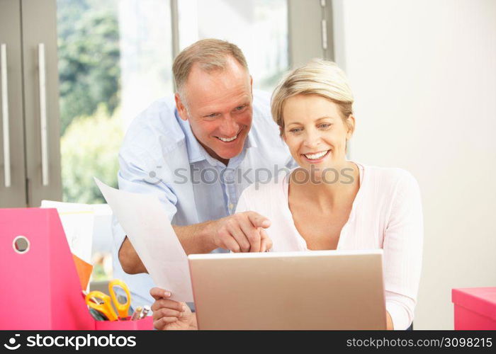 Couple Using Laptop At Home