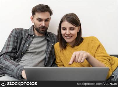 couple using laptop home