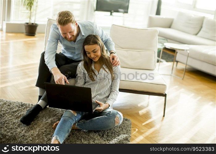 Couple using laptop in the room