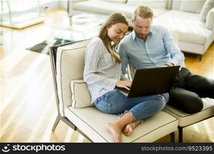 Couple using laptop in the room