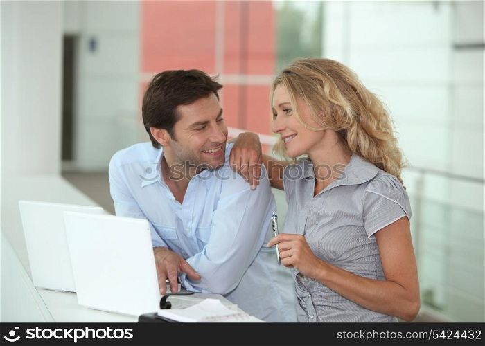 Couple using two laptops