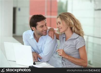 Couple using two laptops