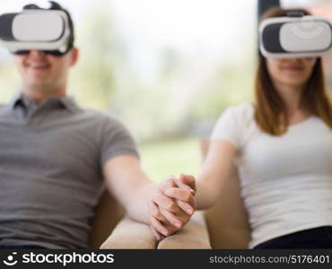 Couple using virtual reality headset in living room at home people playing game with new trends technology