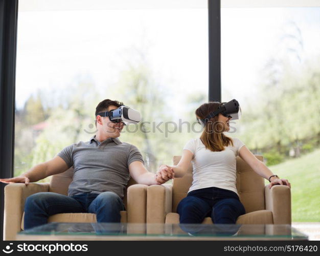 Couple using virtual reality headset in living room at home people playing game with new trends technology