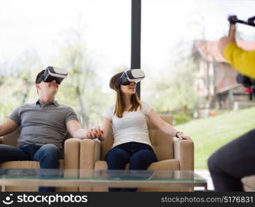 Couple using virtual reality headset in living room at home people playing game with new trends technology