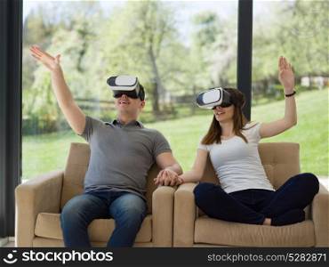 Couple using virtual reality headset in living room at home people playing game with new trends technology
