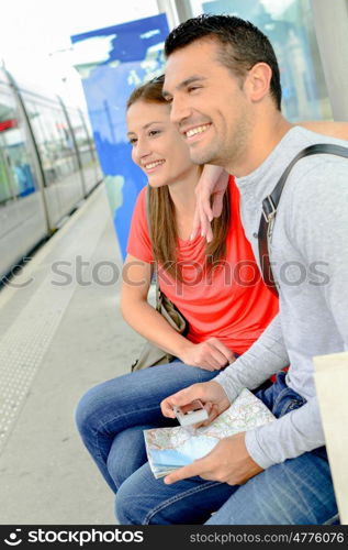 Couple waiting at train station