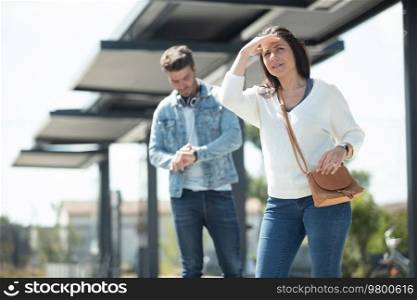 couple waiting for public transport to arrive