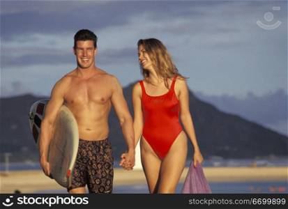 Couple Walking Along Beach