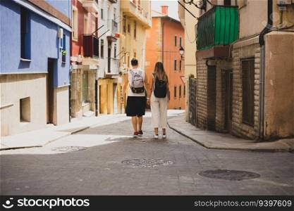 Couple walking by the pintoresque village of Bermeo in Vizcaya, Spain
