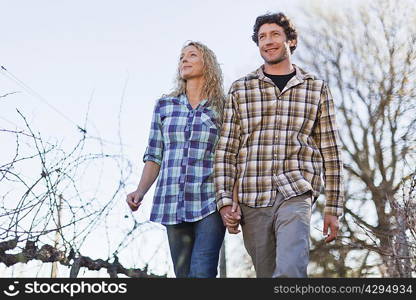 Couple walking hand-in-hand outdoors