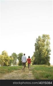 Couple walking in field