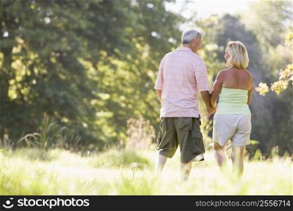 Couple walking in park holding hands