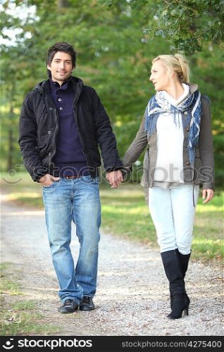 couple walking in the park hand in hand