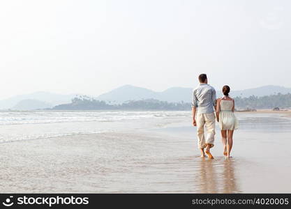 Couple walking in the sea