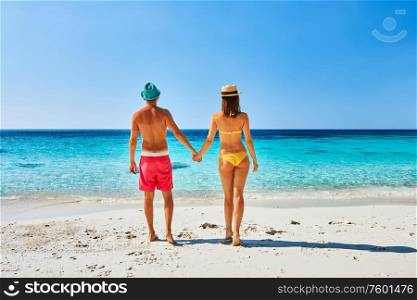Couple walking on a tropical beach. Perhentian islands, Malaysia.