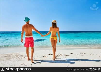 Couple walking on a tropical beach. Perhentian islands, Malaysia.