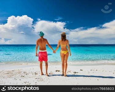 Couple walking on a tropical beach. Perhentian islands, Malaysia. 