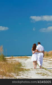 Couple Walking on An Empty Beach