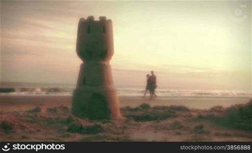Couple Walking on Beach at Sunrise Holding Hands. Themes: family, vacations, summer, fun, travel, meditation, exercise, values, retirement, nostalgia, lifestyle, romance, happiness, companionship, relationships, summer, travel, destinations...