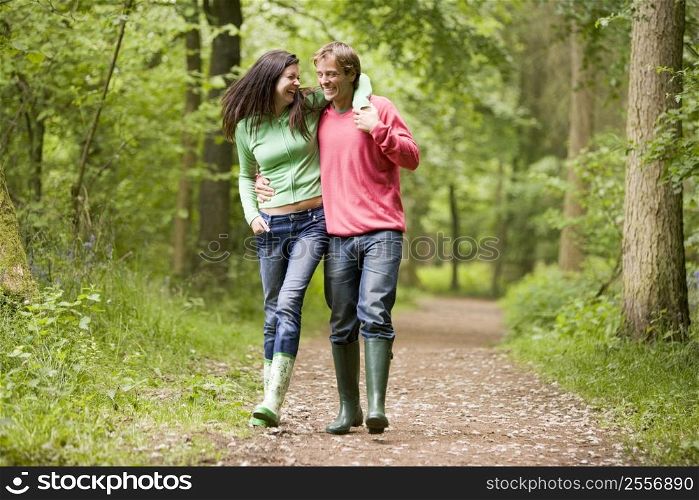 Couple walking on path arm in arm