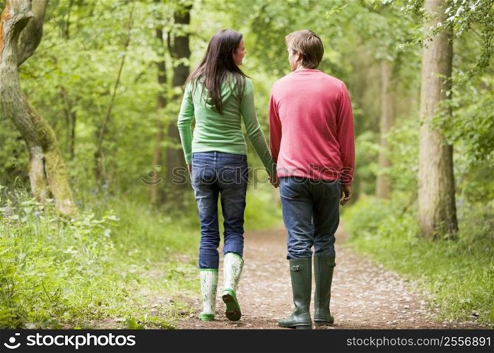 Couple walking on path holding hands