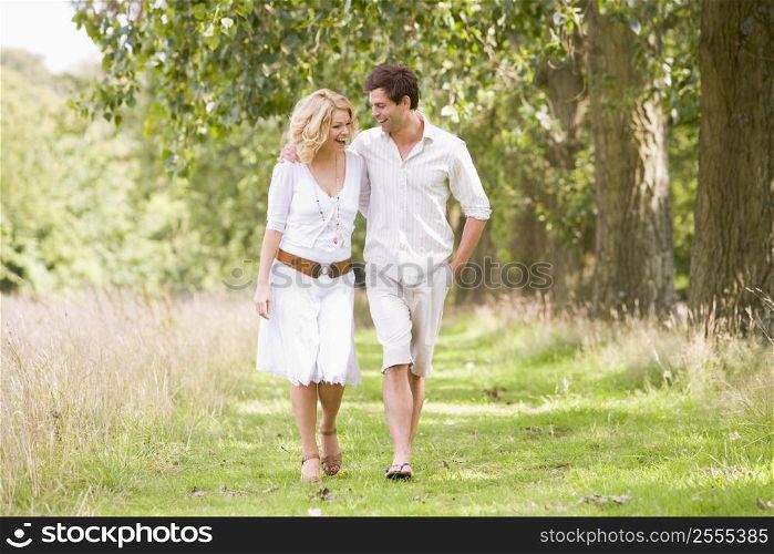 Couple walking on path smiling