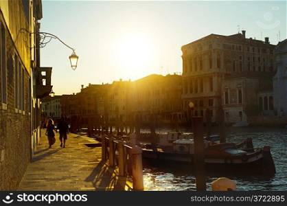 Couple walking on quay in the old town of Venice