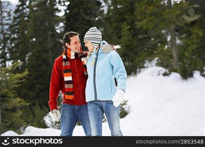 Couple walking on snow-covered path