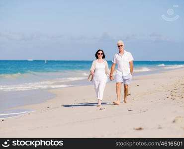 Couple walking on the beach. Walk along the waves