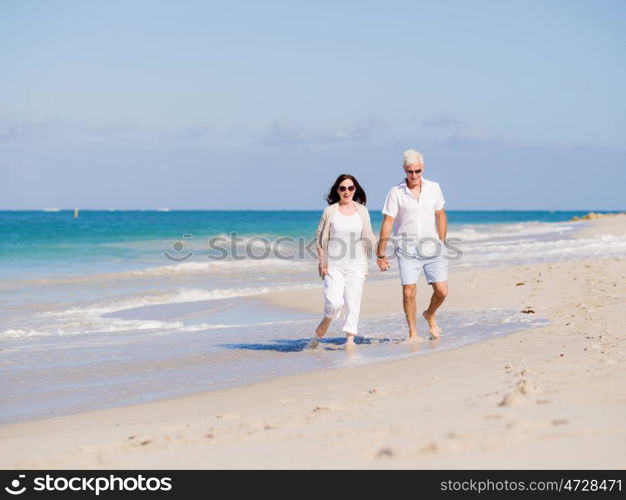 Couple walking on the beach. Walk along the waves