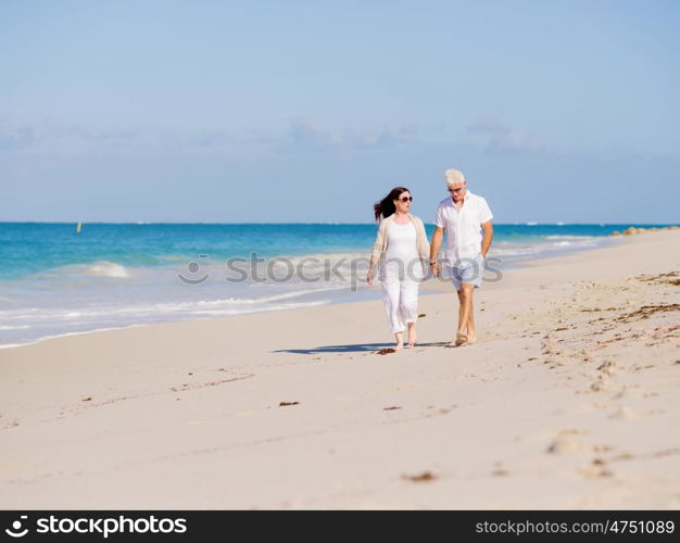 Couple walking on the beach. Walk along the waves