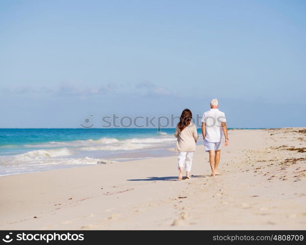 Couple walking on the beach. Walk along the waves