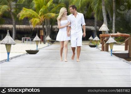 Couple Walking On Wooden Jetty