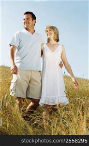 Couple walking outdoors smiling