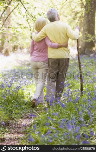 Couple walking outdoors with walking stick