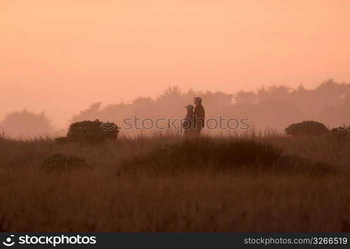 Couple walking through fog