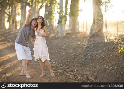 Couple walking together on dirt road