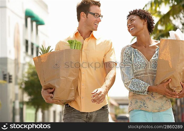 Couple Walking with Groceries in Hand