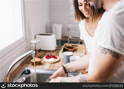 couple washing dishes together