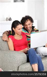 Couple watching a movie on their laptop
