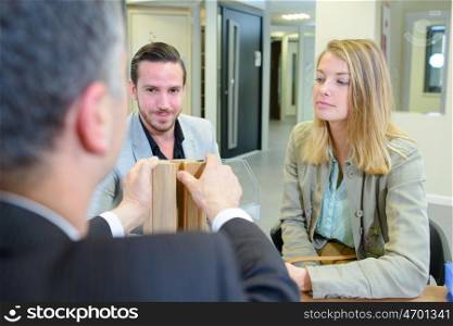 Couple watching demonstration by salesman