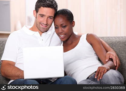 Couple watching DVD on laptop