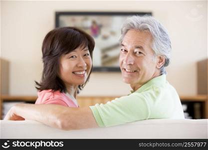 Couple watching television smiling