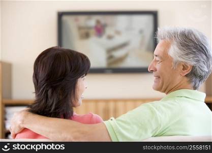 Couple watching television smiling
